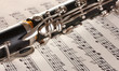 close up detail of clarinet and notebook with notes close up detail of clarinet and notebook with notes