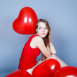Valentines day woman holding red heart balloon Valentines day woman holding red heart balloon
