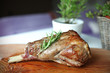 Roasted leg of lamb with rosemary on the cutting board