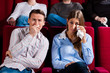Couple and other people in cinema
