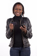 A young woman doing credit card transaction from her phone.
