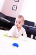 Baby plays in the modern living room. Baby plays in the modern living room.