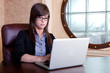 Photo: Businesswoman working on her laptop Businesswoman working on her laptop