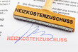 Holzstempel auf Dokument: Heizkostenzuschuss