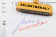Holzstempel auf Dokument: Selbstbehalt