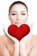 Beautiful woman holding big red heart