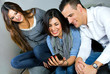 three friends having fun with a mobile phone