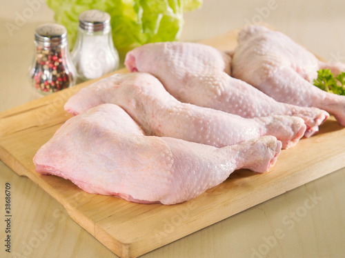 Photo: Fresh raw chicken legs arrangement on kitchen board Fresh raw chicken legs arrangement on kitchen board