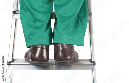 Photo: Feet of worker on steel ladder Feet of worker on steel ladder