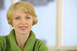 portrait of a woman wearing a green sweater