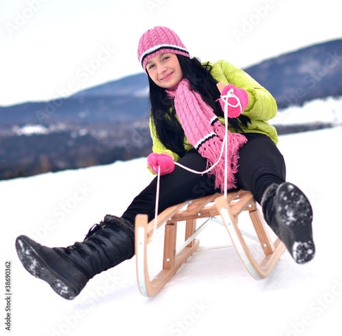 Photo: Young woman in snow with sledge Young woman in snow with sledge