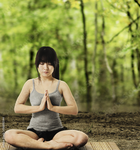 Photo: Asian Woman Meditating in Forest Asian Woman Meditating in Forest