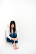 attractive asian woman sitting corner of room