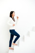 attractive asian woman on stairs in the white room