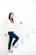 attractive asian woman on stairs in the white room