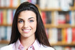 portrait of beautiful young female student in library