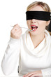 Blindfold woman holding spoon with pile of pills
