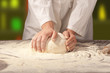 hands kneading bread dough