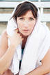 Tired female athlete with towel