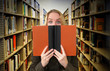 Woman Reading Book in Library