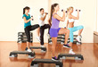 people at the gym exercising with dumbbells
