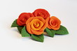 Artificial flowers (four big red roses with green leaves)