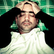 Stressed or mentally disturbed man laying in bed