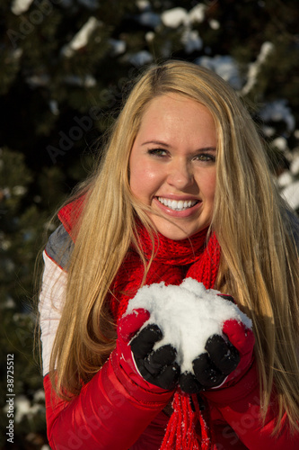 Photo: woman holding snow pile in hands woman holding snow pile in hands