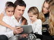 Happy young family using a tablet computer Happy young family using a tablet computer