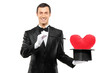 Magician holding a magic wand and top hat with a red heart shape