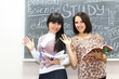 Two students near the blackboard Two students near the blackboard