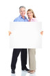 Senior happy couple with placard.