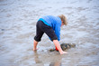 boy is playing in the sand