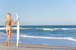 Beautiful Woman Surfer In Bikini With Surfboard At Beach