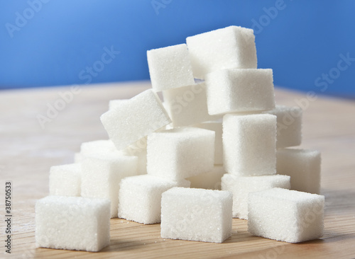 Photo: sugar cubes on wooden table sugar cubes on wooden table