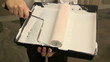 Dipping paint roller into tray and painting a wall