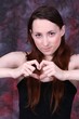 heart with human hands of y young woman