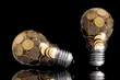 Foto: Traditional glass bulb with many golden coins on black Traditional glass bulb with many golden coins on black