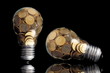 Traditional glass bulb with many golden coins on black Traditional glass bulb with many golden coins on black