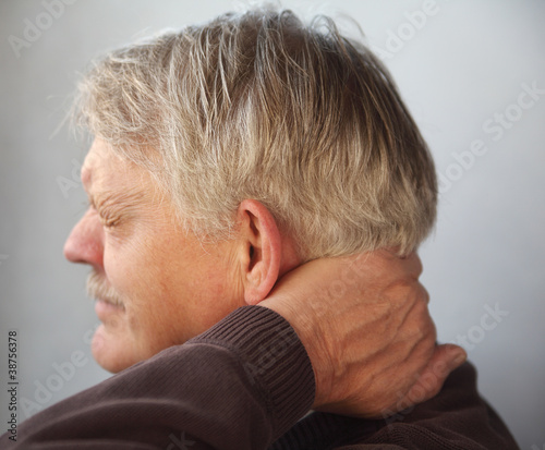 Photo: senior man with aching neck senior man with aching neck