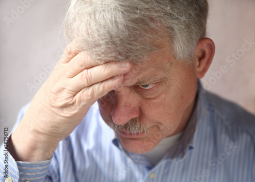 Photo: disturbed and suspicious older man disturbed and suspicious older man