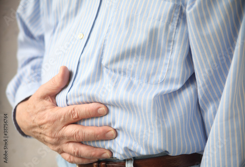 Photo: businessman with indigestion or stomach pain businessman with indigestion or stomach pain