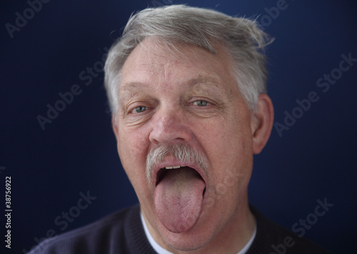 Photo: older man showing his tongue older man showing his tongue