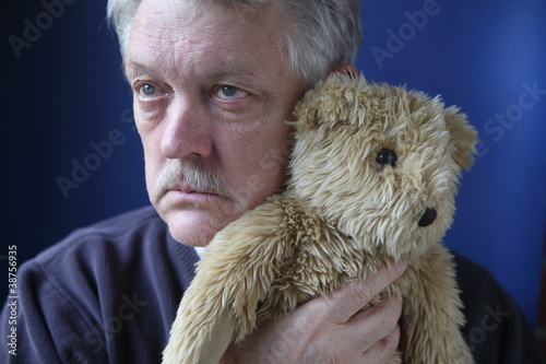 Photo: senior man holding teddy bear senior man holding teddy bear