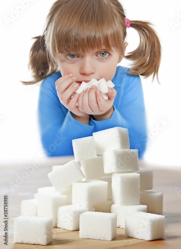 Photo: little girl with sugar cubes little girl with sugar cubes