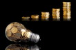 Traditional glass bulb with many golden coins on black Traditional glass bulb with many golden coins on black