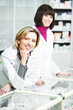 Photo: Two Pharmacy chemist women in drugstore Two Pharmacy chemist women in drugstore