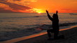 Woman Praying At Sunset