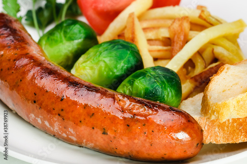 Photo: German sausage with potatoes and vegetables. German sausage with potatoes and vegetables.