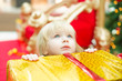 Young girl among christmas gifts